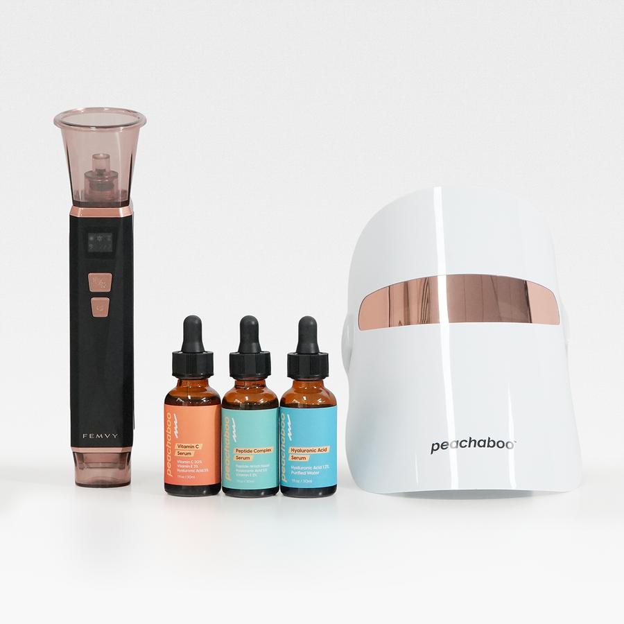 A set of Beauty Device including black Femvy Blackhead Vacuum remover, Peachaboo Vitamin C Serum, Peachaboo Peptide Serum,  Peachaboo Hyaluronic Serum and Peachaboo Glo LED Light Therapy Mask in white background