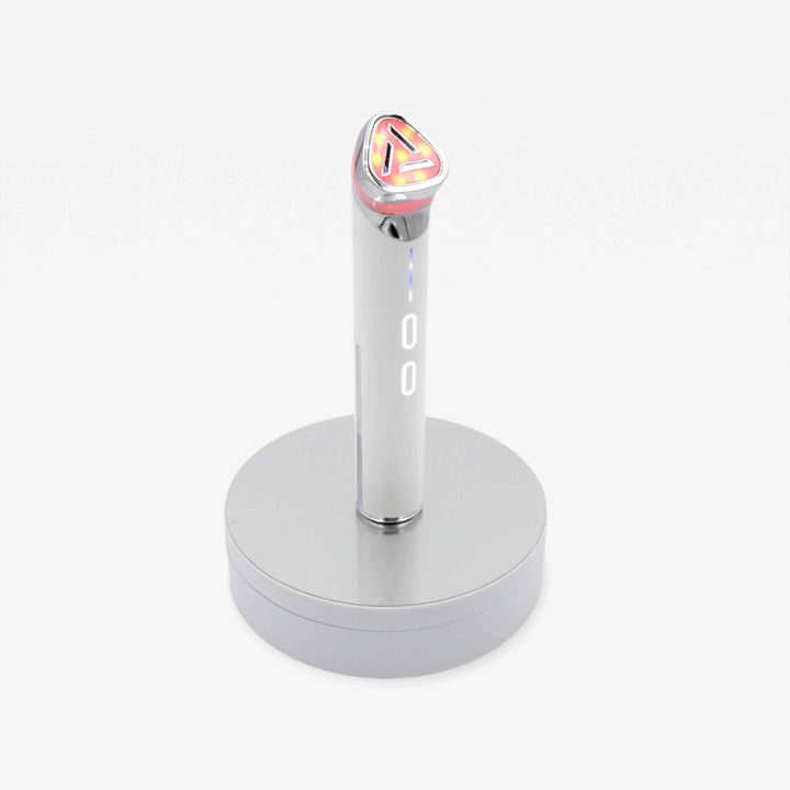 A chic silver and pink wand on a stand, representing the perfect blend of design and efficiency for your beauty needs.