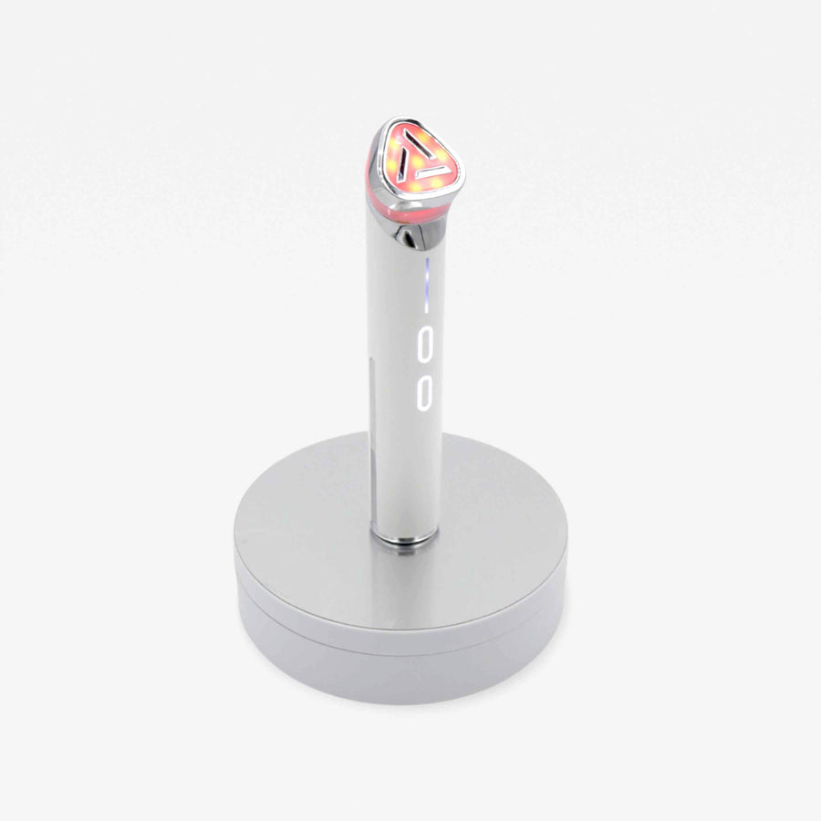A chic silver and pink wand on a stand, representing the perfect blend of design and efficiency for your beauty needs.