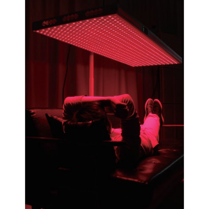 a man using Horizontal Stand for PeakMe Red Light Therapy Panel