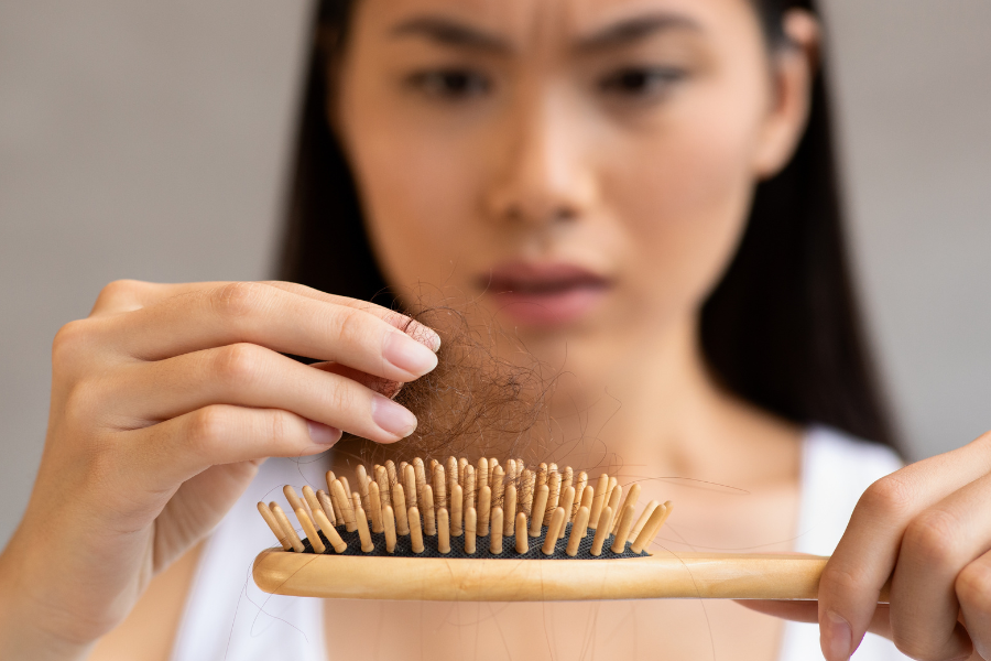 a woman losing hairs