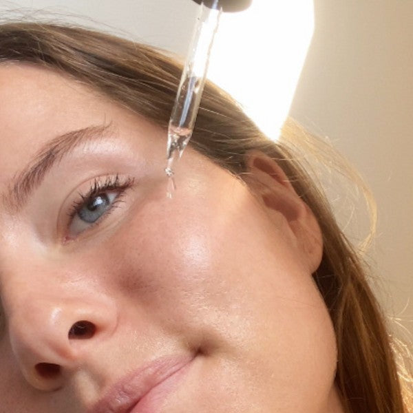 A woman using Peachaboo Retinol Serum on her skin