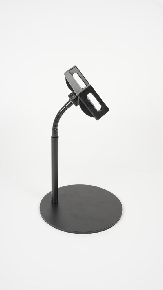  A black device mounted on the wall with an adjustable stand