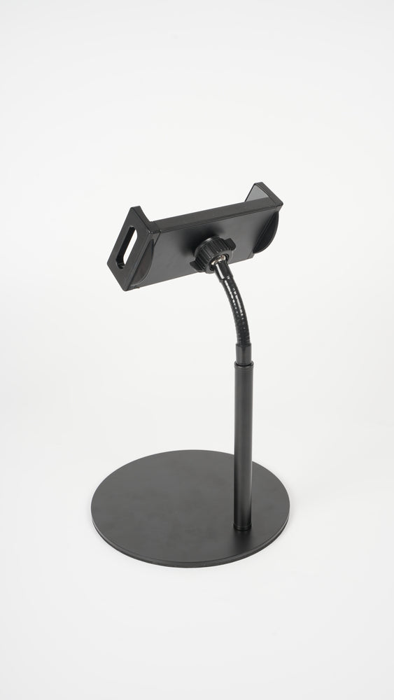  A black device mounted on the wall with an adjustable stand