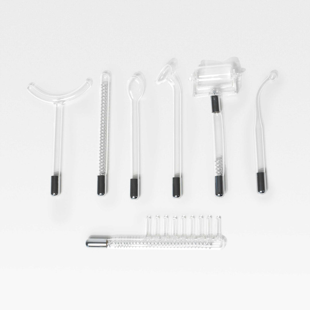 Peachaboo High-Frequency Therapy Wand glass electrode attachments arranged on a white surface.