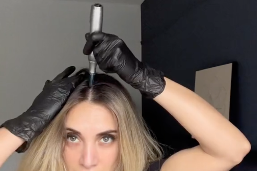 a woman using Dr. Pen M8S for microneedling on scalp
