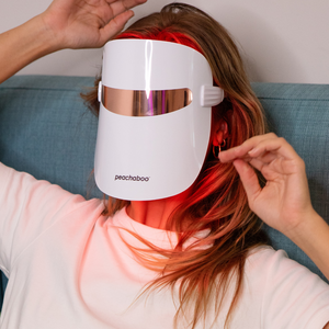 a woman using Peachaboo Glo LED Light Therapy Mask