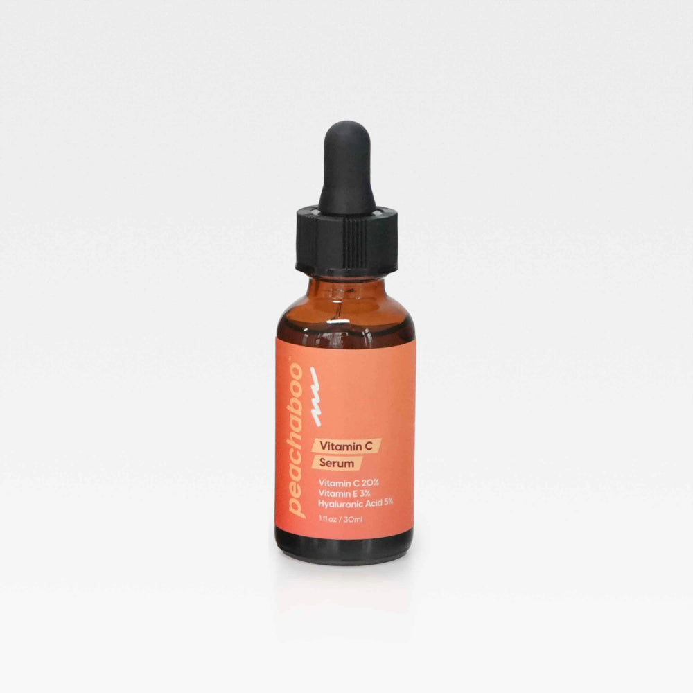 A Peachaboo Vitamin C Serum bottle on a white backdrop, showcasing the product's clarity and appealing design.