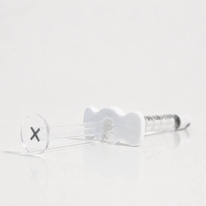 Reglory HL 40+ Hyaluronic Acid Skin Booster syringe lying on a white reflective surface