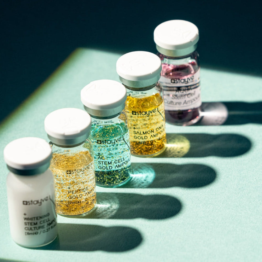 Collection of Stayve ampoules with visible branding on a light green surface.