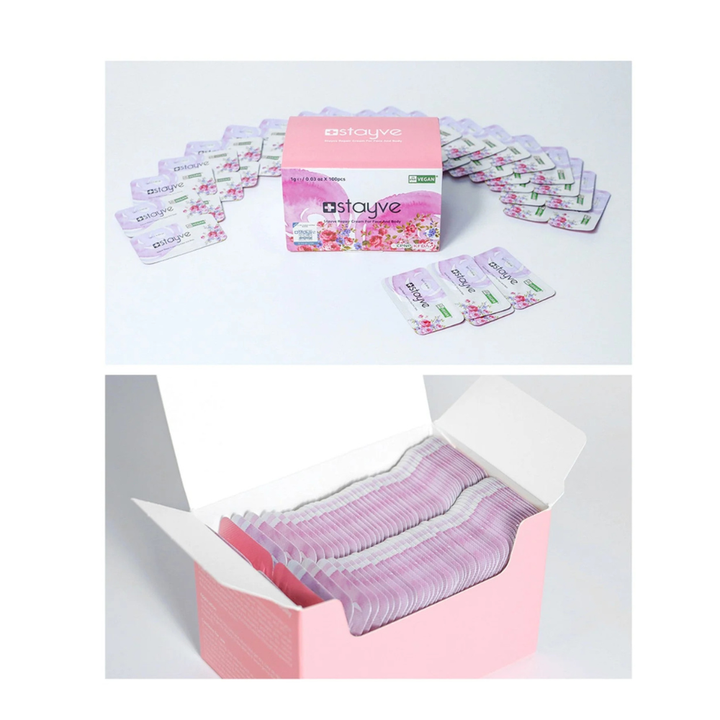 Stayve Repair Cream For Face And Body box with sachets around the packaging, and neatly stacked inside an open box.