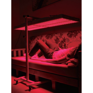 a man using Horizontal Stand for PeakMe Red Light Therapy Panel 