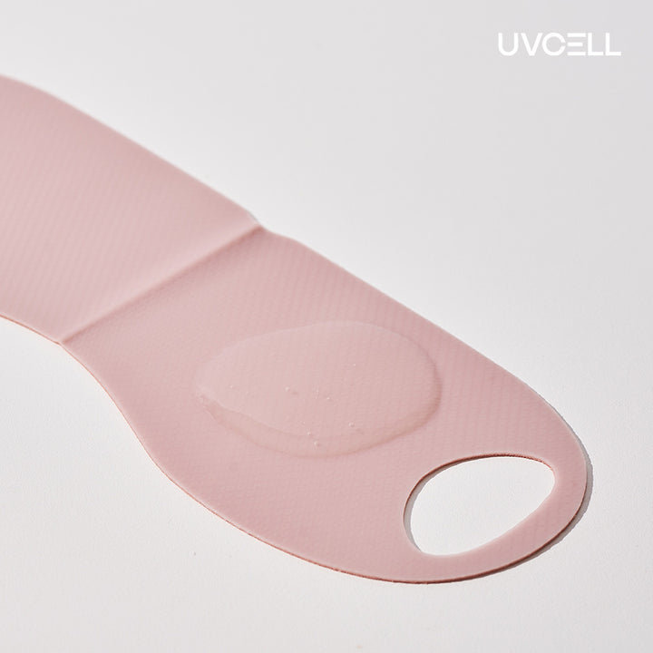 Close-up of the pink Super Collagen V-Lifting Mask showing its flexibl e sheet material and serum texture.