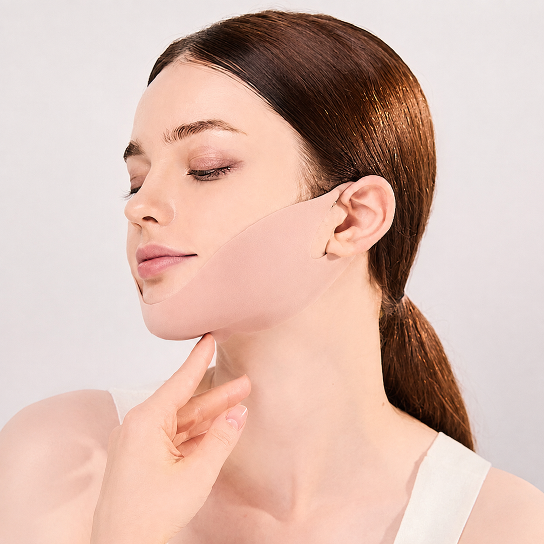 Side profile of a woman wearing the Super Collagen V Lifting Mask along the jawline with her hand gently touching under the chin.