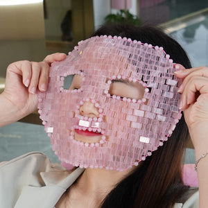 image of a woman puting on rose quartz face mask